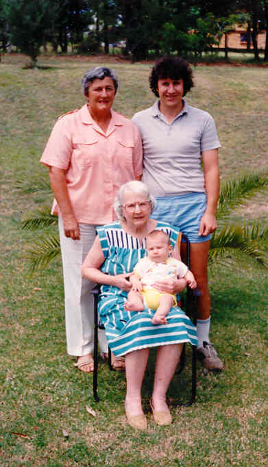 Four Generations Pan and her son Rodney, standing, Helen seated nursing her great-grandson, Anthony. Mulgoa, N.S.W. December 1987.